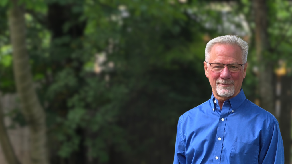 Smiling man in blue shirt