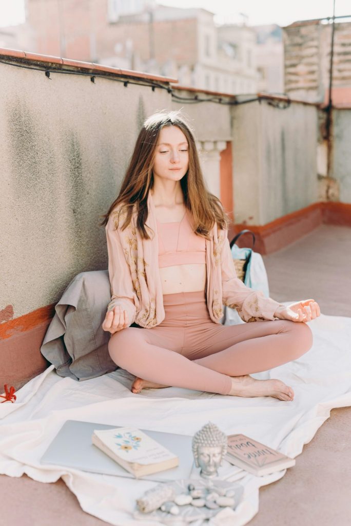 Woman meditating on rooftop